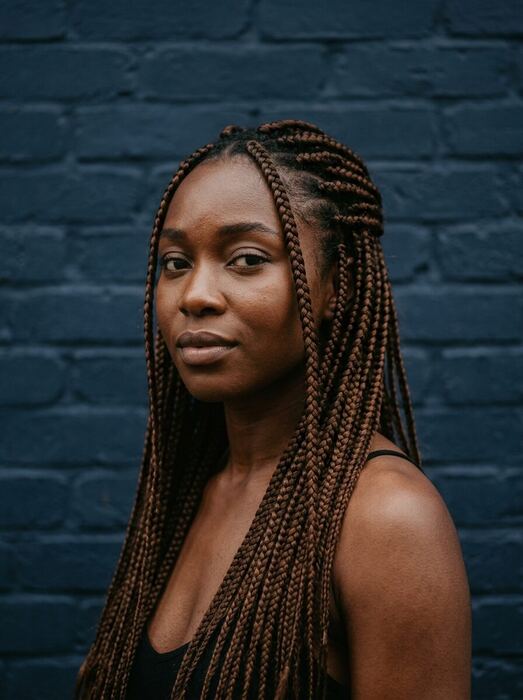 A woman with waist-length knotless box braids
